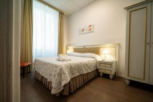 a hotel room with a bed and a window at Hotel Genova Liberty in Genoa