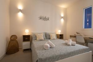 a bedroom with a bed with towels on it at Montebello Room's in Marettimo