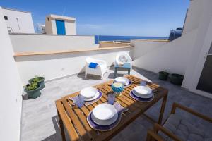 a table with hats and plates on top of a balcony at Montebello Room's in Marettimo