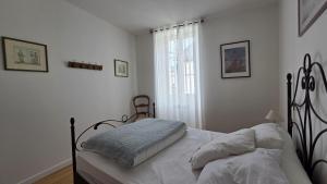 a bedroom with a bed and a window at Gîte du moulin d'Arudy en Vallée d'Ossau in Arudy
