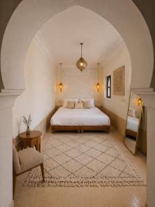 a bedroom with a bed and an arched ceiling at Riad Aura Suites & Spa in Marrakesh +42 photos