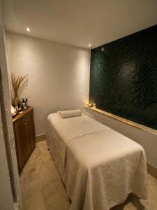 a bedroom with a bed and a large window at Riad Aura Suites & Spa in Marrakesh