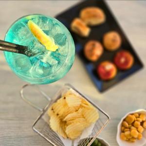 a table with a drink and a plate of food at Respiro Di Mare in Torre del Greco