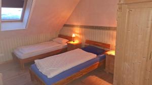 a small room with two beds and a window at Darpvenner Diele in Ostercappeln