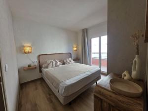 a bedroom with a large bed and a sink at Salles Beach 33 in L'Estartit +58 photos
