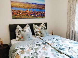 a bedroom with a bed with a painting on the wall at Mein Wein Apartment in Krems an der Donau