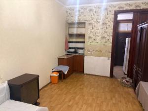 a small room with a kitchen with wooden floors at На Еврейской in Odesa +10 photos