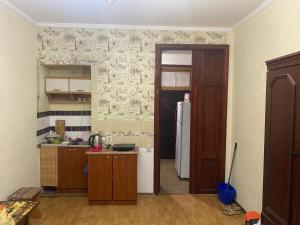 a kitchen with a door open to a kitchen with a refrigerator at На Еврейской in Odesa