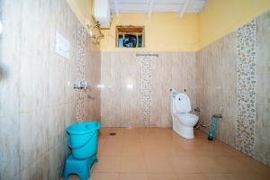 a bathroom with a blue toilet and a shower at Forest Rest House Gahan in Bāgi +12 photos