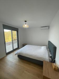 a bedroom with a bed and a large window at Contemporary villa with pool and sea view in Poulithra