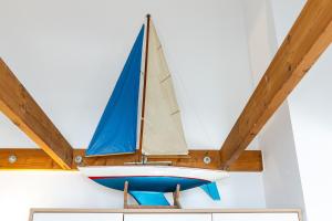 a sail boat hanging from a ceiling at Strandhotel Laboe Nr 35 in Laboe