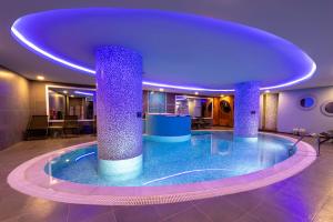 a large swimming pool with two pillars in a building at Miapera Hotel & Spa - Special Class in Istanbul