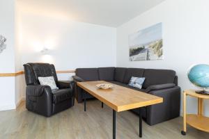 a living room with a couch and a table and chairs at Strandhotel Laboe Nr 35 in Laboe +35 photos