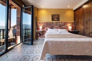 a bedroom with a bed and a brick wall at Hotel Cerro La Nina in Beceña +144 photos