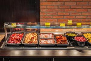 a buffet line with many different types of food at Komló Hotel Gyula in Gyula