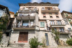 a tall building with balconies on the side of it at Menaggio Tosca Apartments in Menaggio