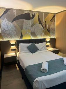 a bedroom with a large bed with a mural on the wall at Airway Motel in Brisbane