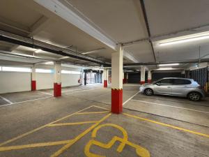 a parking garage with a car parked in it at Citrus Hotel Cheltenham by Compass Hospitality in Cheltenham