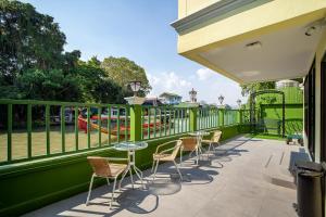 a balcony with chairs and tables and a playground at Bangluang Boutique Hotel nearby Wat Arun in Bangkok