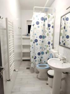 a bathroom with a toilet and a shower curtain at The High Hostel in Budva