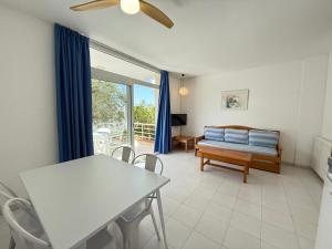 a living room with a couch and a table at Agi Rescator Apartments in Roses