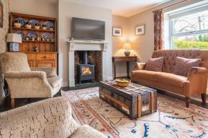 a living room filled with furniture and a fireplace at Mollies Cottage in Overstrand