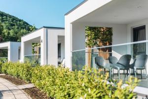 an exterior view of a house with chairs on the balcony at Mobile Homes Camping Plitvice in Smoljanac