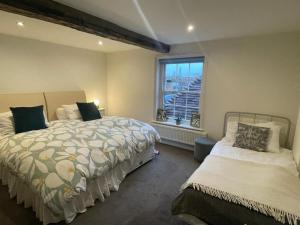 a bedroom with two beds and a window at Large town centre apartment with parking in Wallingford