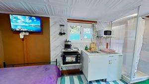a small kitchen with a stove and a tv on the wall at Apartaments Segur Kandy 1 in Calafell