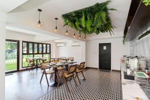 a restaurant with tables and chairs in a room at Bangluang Boutique Hotel nearby Wat Arun in Bangkok
