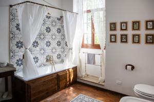 a bathroom with a tub and a toilet and a window at Villa Guarienti Valpolicella in Fumane +49 photos