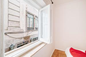an empty room with a window and a bed at Casas da Biquinha in Sintra +104 photos