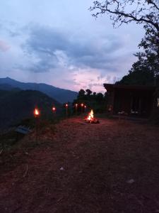 a bonfire in the middle of a field at night at Trekker's Lodge in Matale