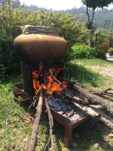 a pot sitting on top of a fire at BIG J'S Farm House in Dhulikhel