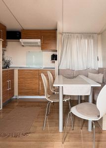a kitchen with a table and chairs in a room at Auto-kamp Dvije suze 1 in Brištane