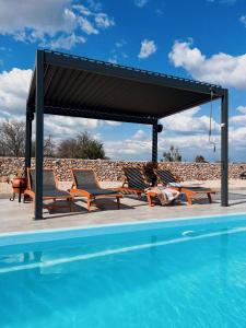 a gazebo with chairs and a swimming pool at Auto-kamp Dvije suze 1 in Brištane