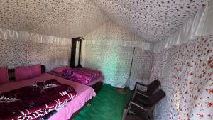 a bedroom with two beds in a tent at Lord Shiva Camps in Sari