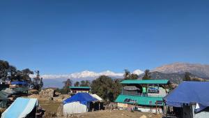 a group of tents with mountains in the background at Lord Shiva Camps in Sari +14 photos