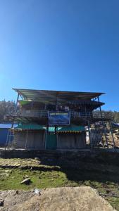 a building with a roof on top of it at Lord Shiva Camps in Sari