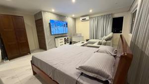 a bedroom with a large bed and a living room at Modern Studio with Stylish Interior in Dorp Sint Michiel