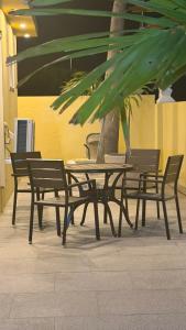 a table and chairs with a tree in a building at Modern Studio with Stylish Interior in Dorp Sint Michiel