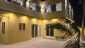 a yellow house with lights on the side of it at Modern Studio with Stylish Interior in Dorp Sint Michiel