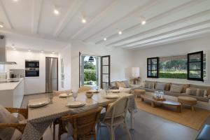 a dining room and living room with a table and chairs at Racó 24 in Pals