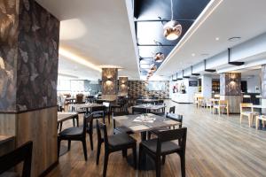 a dining room with wooden tables and chairs at THE Pretoria Hotel in Pretoria