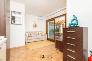 a living room with a couch and a dresser at Elite Collection Domo Mea Private Pool in Olbia +27 photos