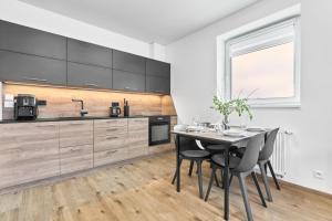 a kitchen with a table and chairs in a room at Klínovec 301 by Mountain ways in Loučná pod Klínovcem