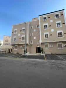 a large apartment building with a parking lot at درة القيم in Taif