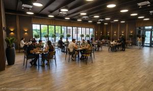 a group of people sitting at tables in a restaurant at Yerevan Street hotel in Yerevan
