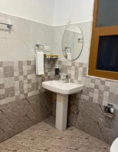a bathroom with a sink and a mirror at Rivanta Resort Kasol in Kasol
