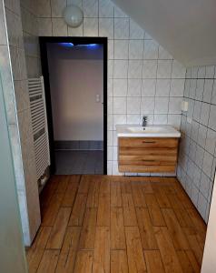 a bathroom with a sink and a mirror and a door at Camping und Chalet Saggraben in Palfau +24 photos